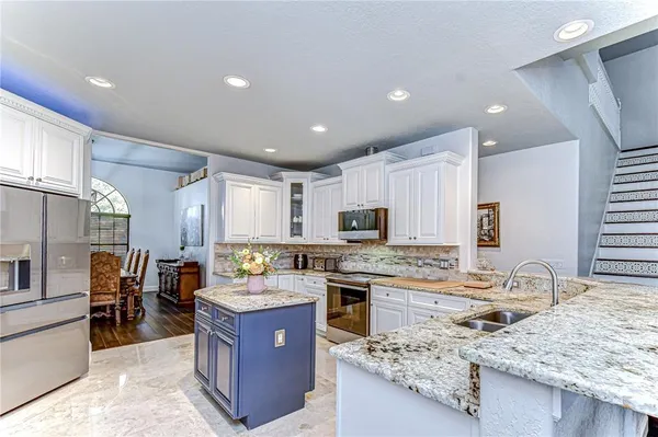 a bedroom with a bed and glass walk in closet