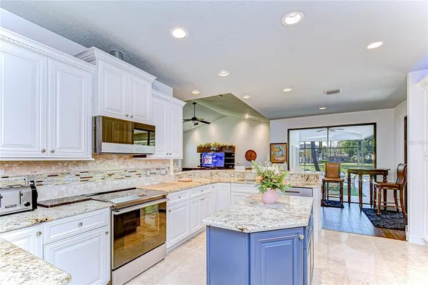 a dining room with furniture a chandelier and wooden floor