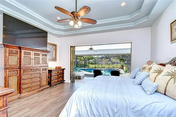 a living room with furniture a flat screen tv and a large window