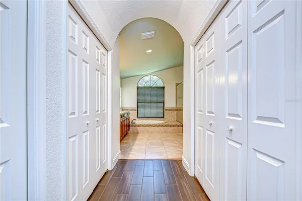 a bathroom with a tub sink and mirror