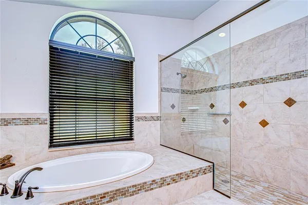 a view of a workspace with furniture bookshelf and a window