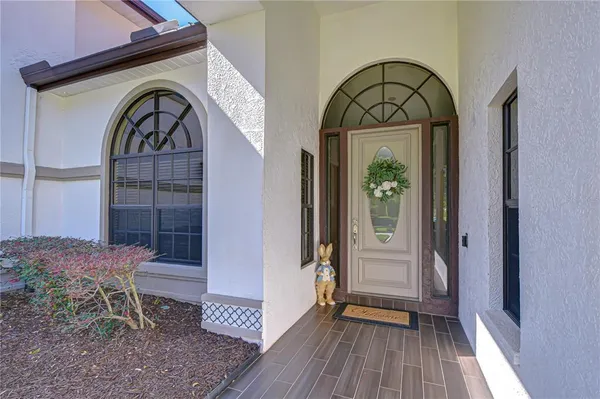 a living room with furniture a rug and a chandelier