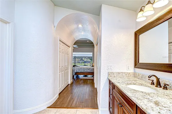 a bathroom with a granite countertop sink and a mirror
