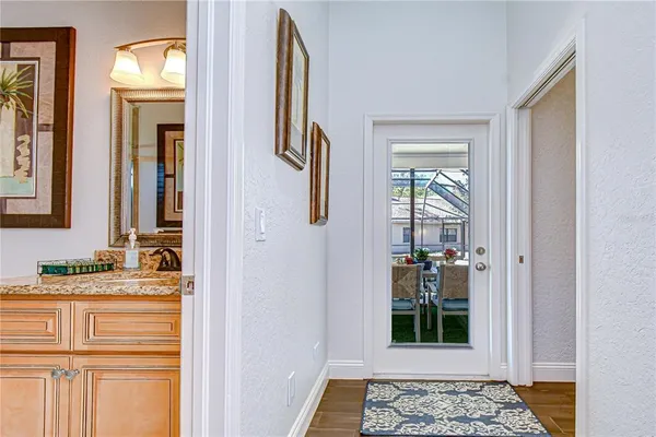 a view of a dining room with furniture a rug and a floor to ceiling window