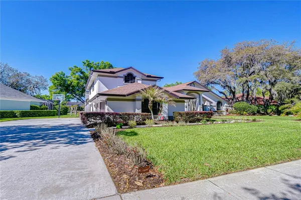 a view of a house with a yard porch and sitting area