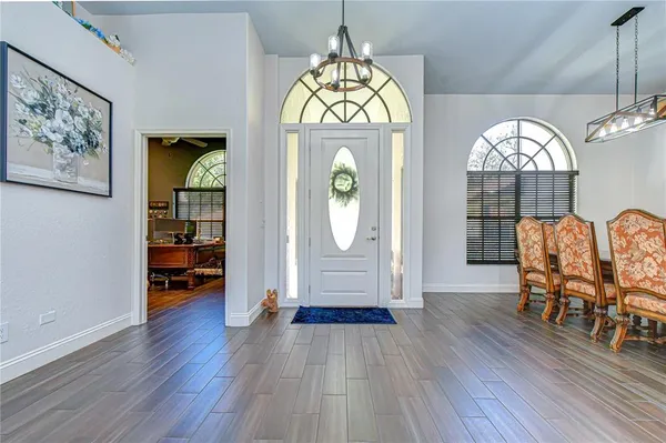a living room with furniture a rug and a chandelier