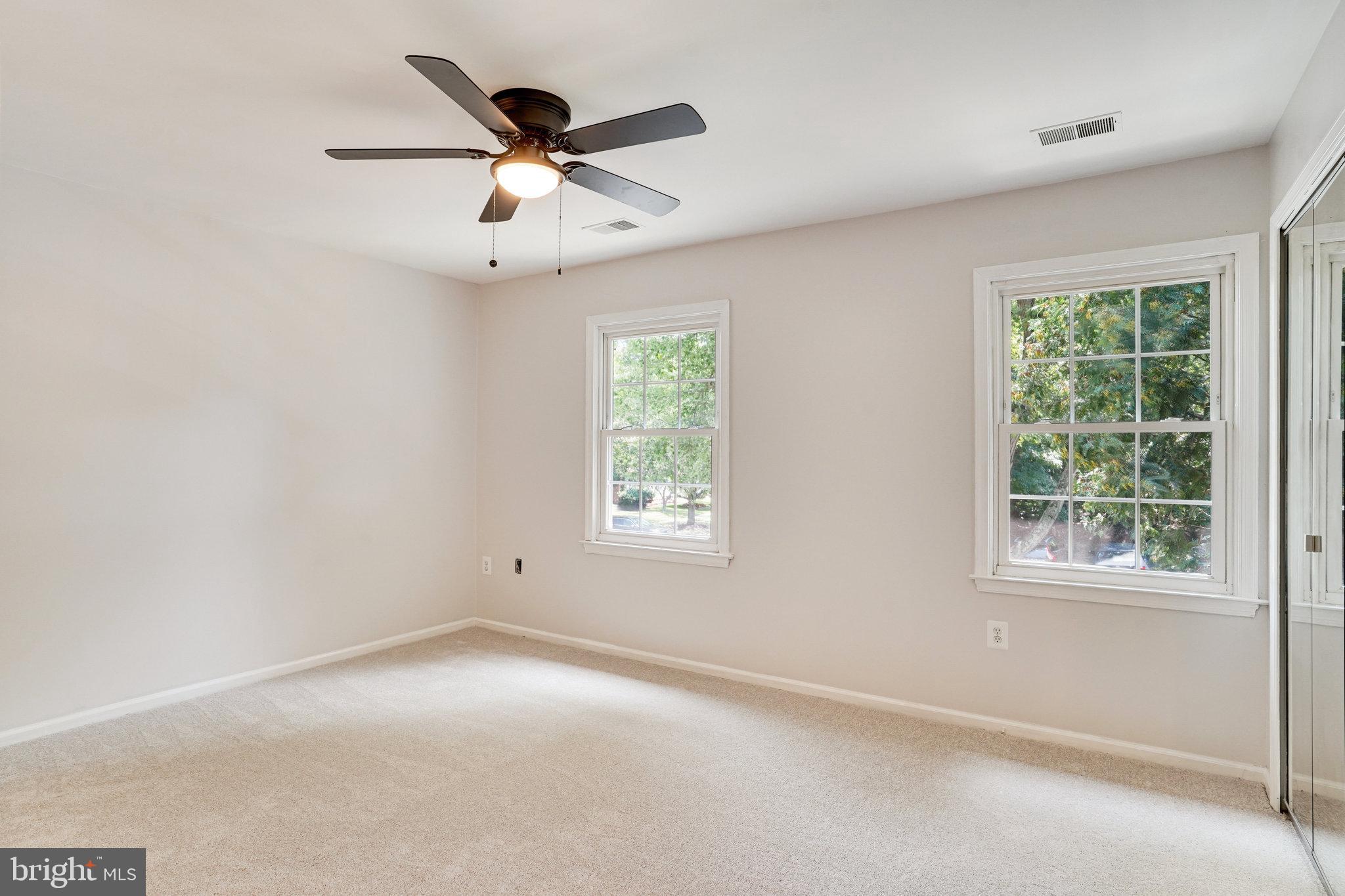 7918 Pebble Brook Court Springfield, VA 22153 - Photo 11 of 28 an empty room with windows and fan