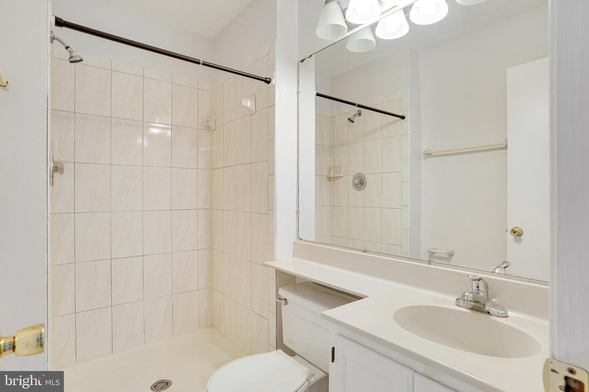 7918 Pebble Brook Court Springfield, VA 22153 - Photo 13 of 28 a bathroom with a sink toilet and shower