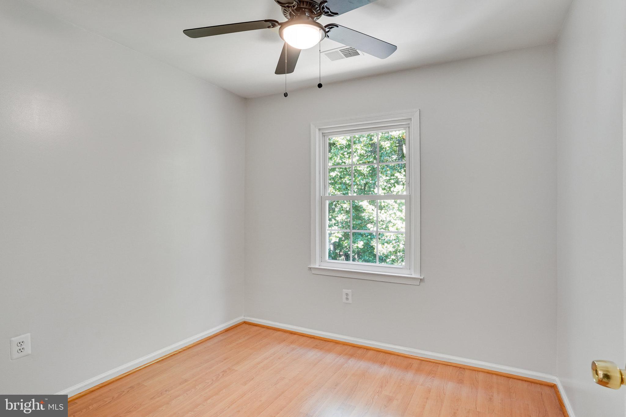 7918 Pebble Brook Court Springfield, VA 22153 - Photo 17 of 28 an empty room with a window and a fan