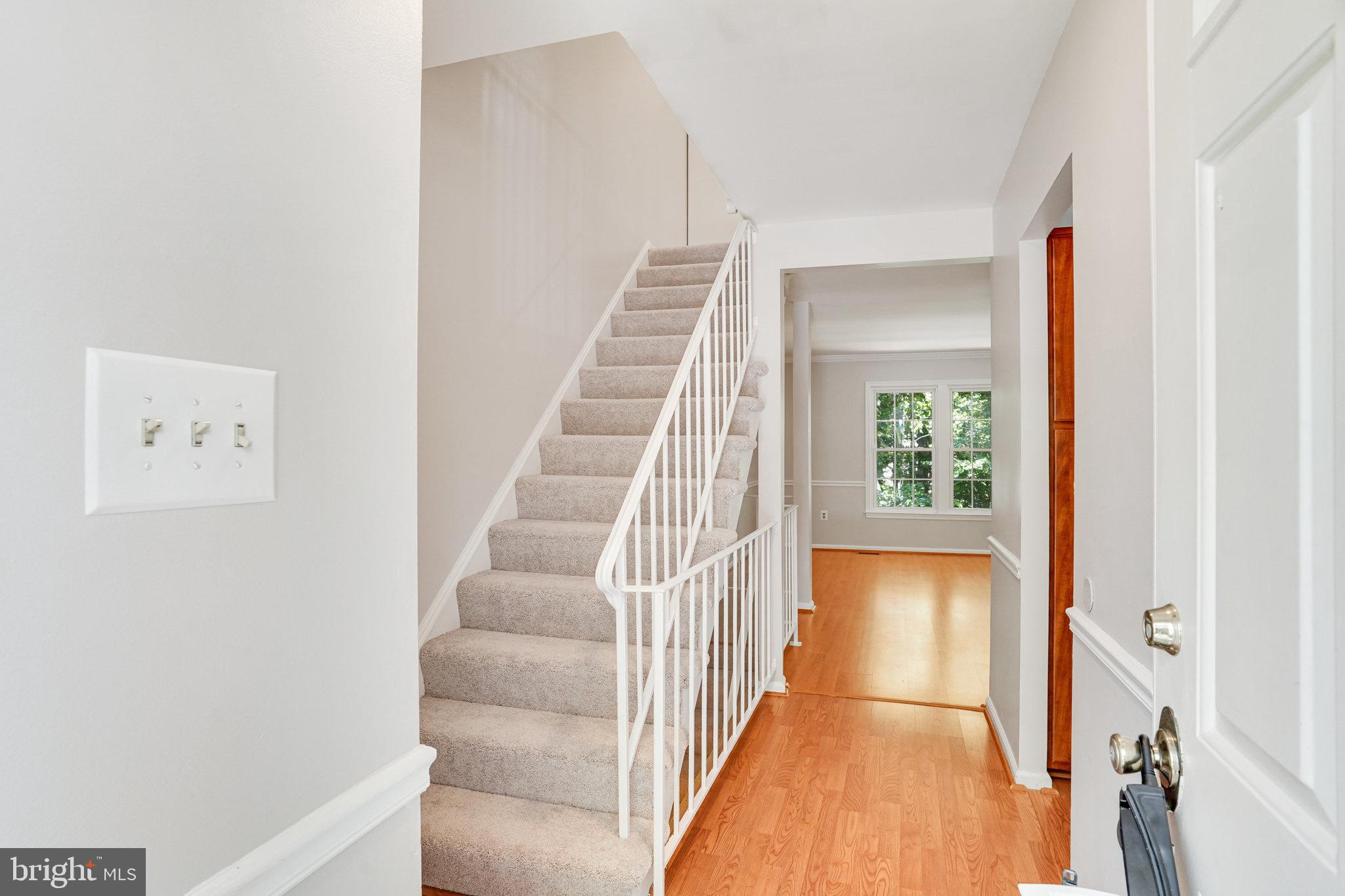 7918 Pebble Brook Court Springfield, VA 22153 - Photo 3 of 28 a view of a hallway with entryway wooden floor and front door
