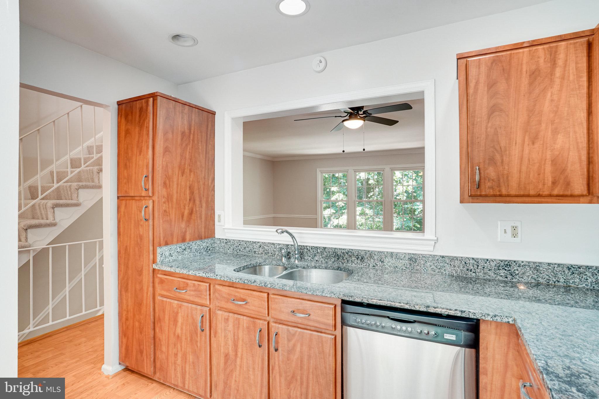 7918 Pebble Brook Court Springfield, VA 22153 - Photo 5 of 28 a kitchen with granite countertop a sink and a window