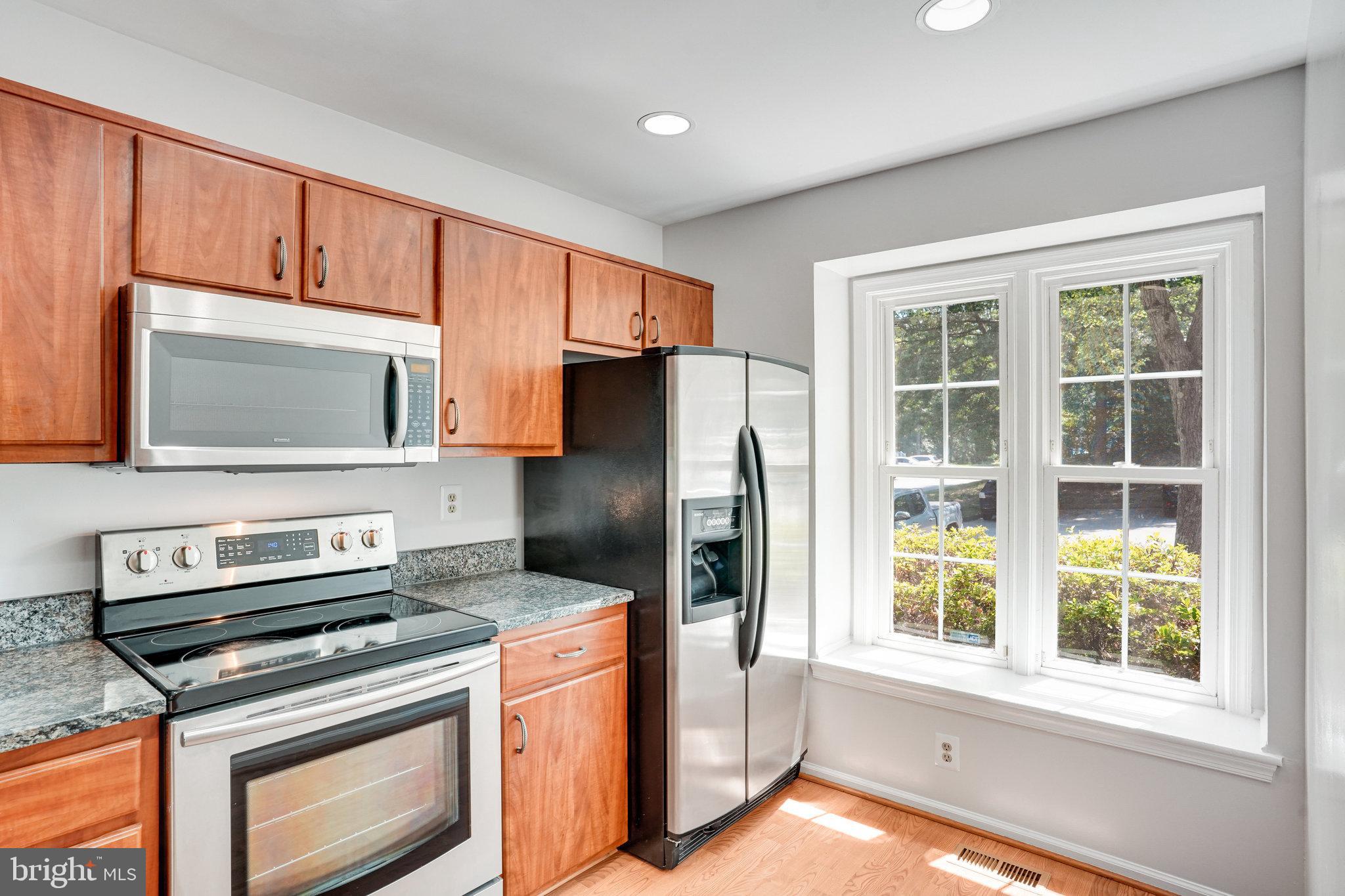 7918 Pebble Brook Court Springfield, VA 22153 - Photo 6 of 28 a kitchen with a stove microwave and refrigerator