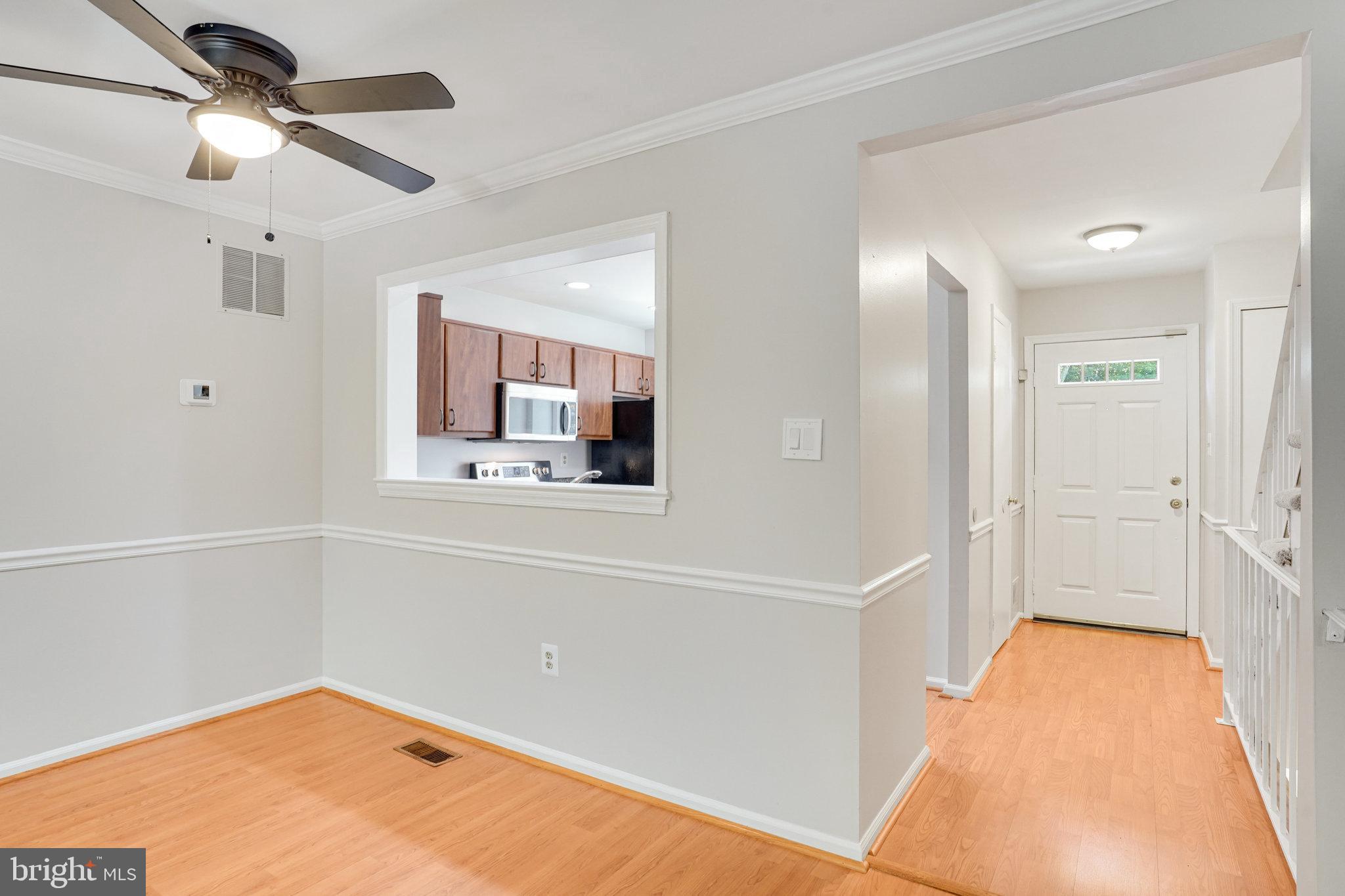 7918 Pebble Brook Court Springfield, VA 22153 - Photo 7 of 28 a view of a hallway with a chandelier