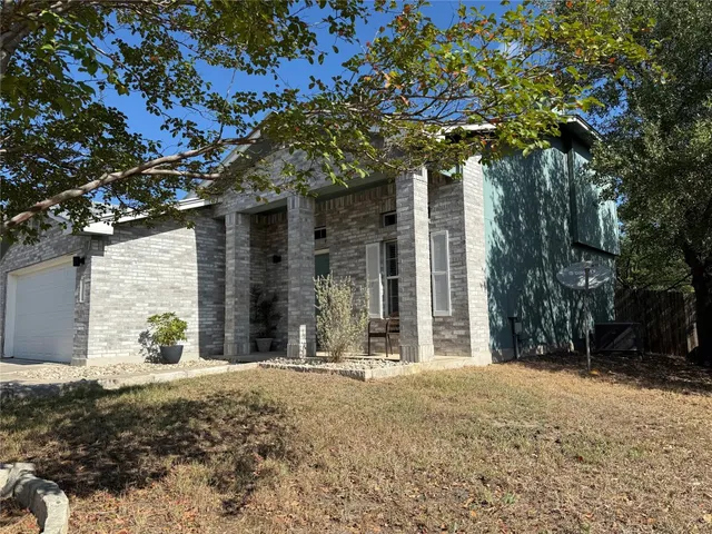 a view of a house with a tree