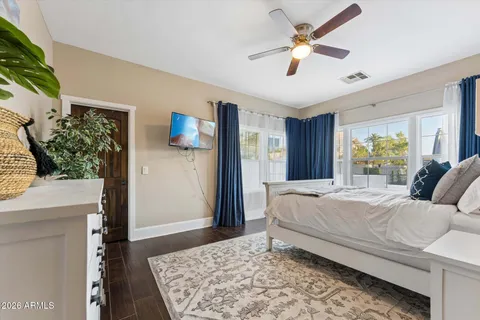 a bedroom with a bed dresser and a window