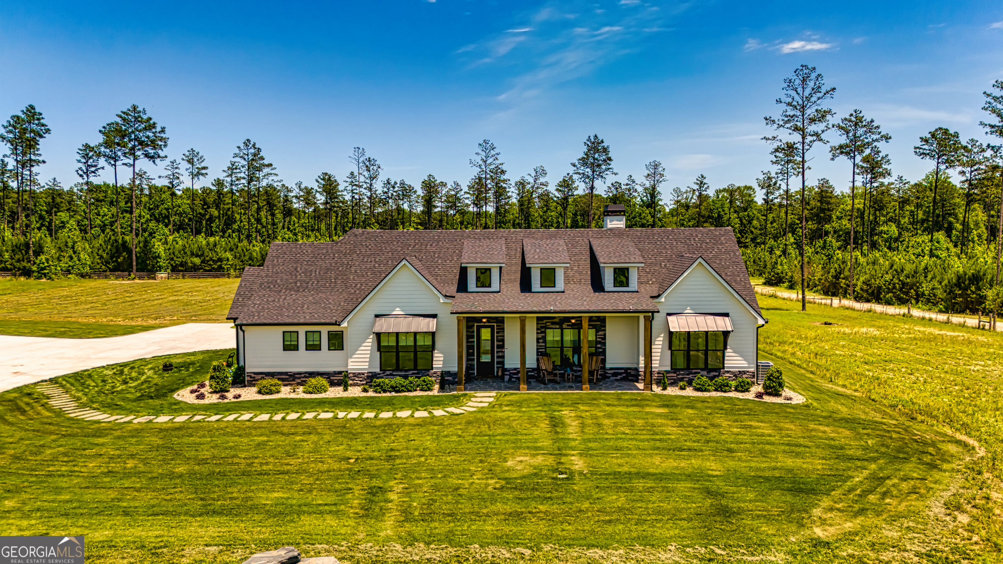 11084 Mt Carmel Road Senoia, GA 30276 - Photo 110 of 136 a front view of a house with a big yard