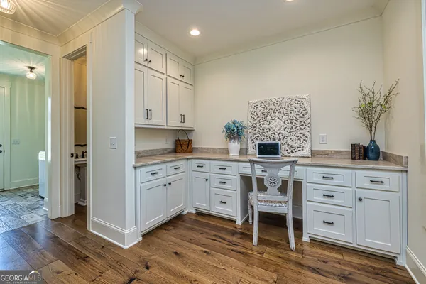 a bathroom with a toilet a sink a mirror and a shower