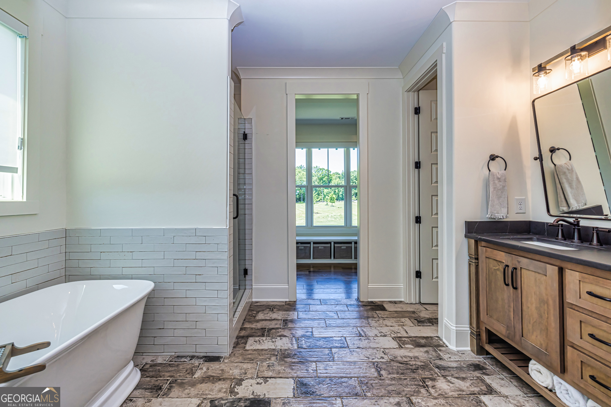 11084 Mt Carmel Road Senoia, GA 30276 - Photo 30 of 136 a bathroom with a tub a sink and a mirror