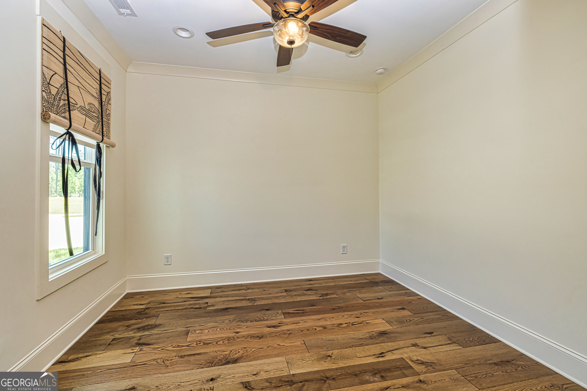 11084 Mt Carmel Road Senoia, GA 30276 - Photo 40 of 136 a view of empty room with wooden floor and fan