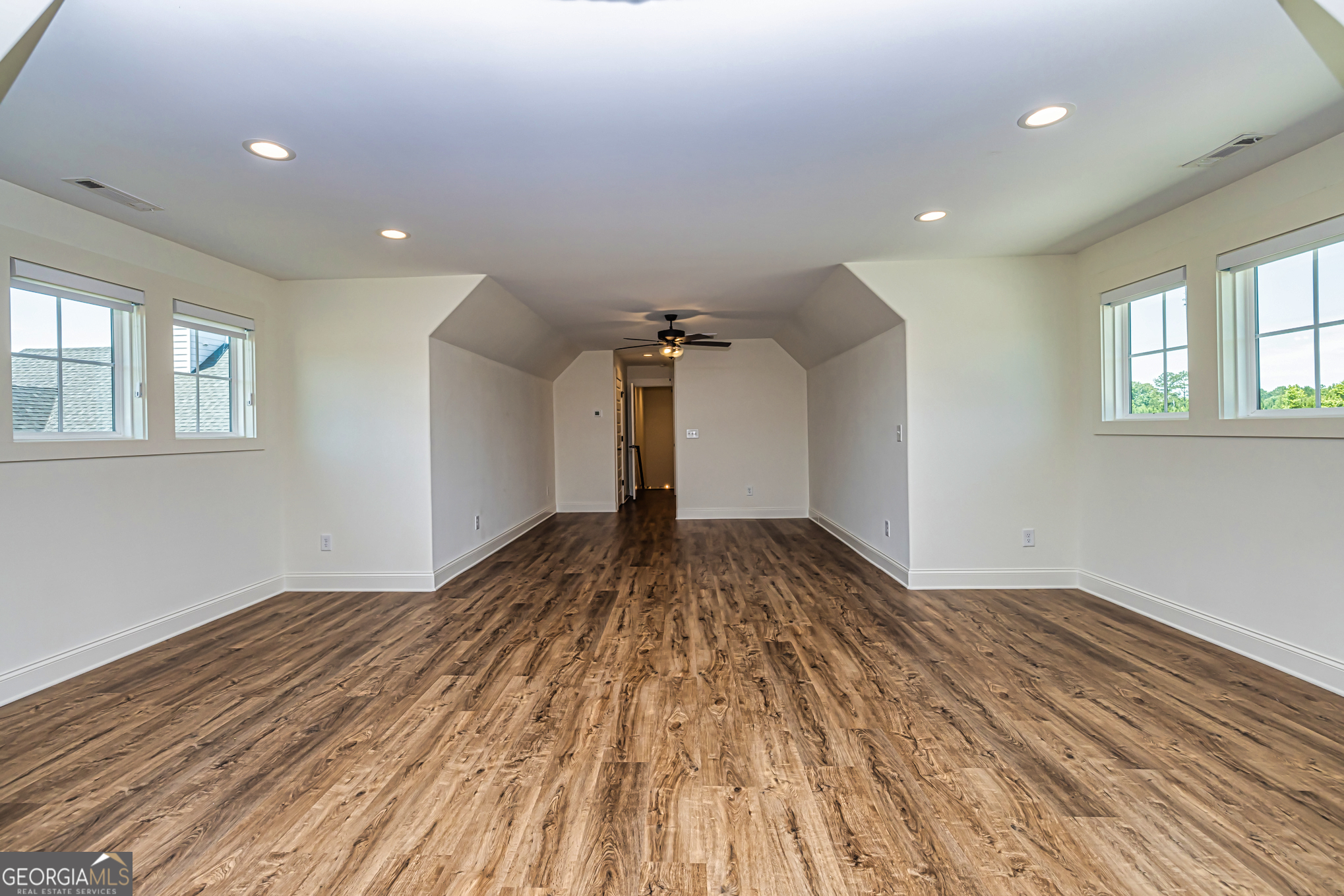 11084 Mt Carmel Road Senoia, GA 30276 - Photo 44 of 136 a view of a room with wooden floor and ceiling fan