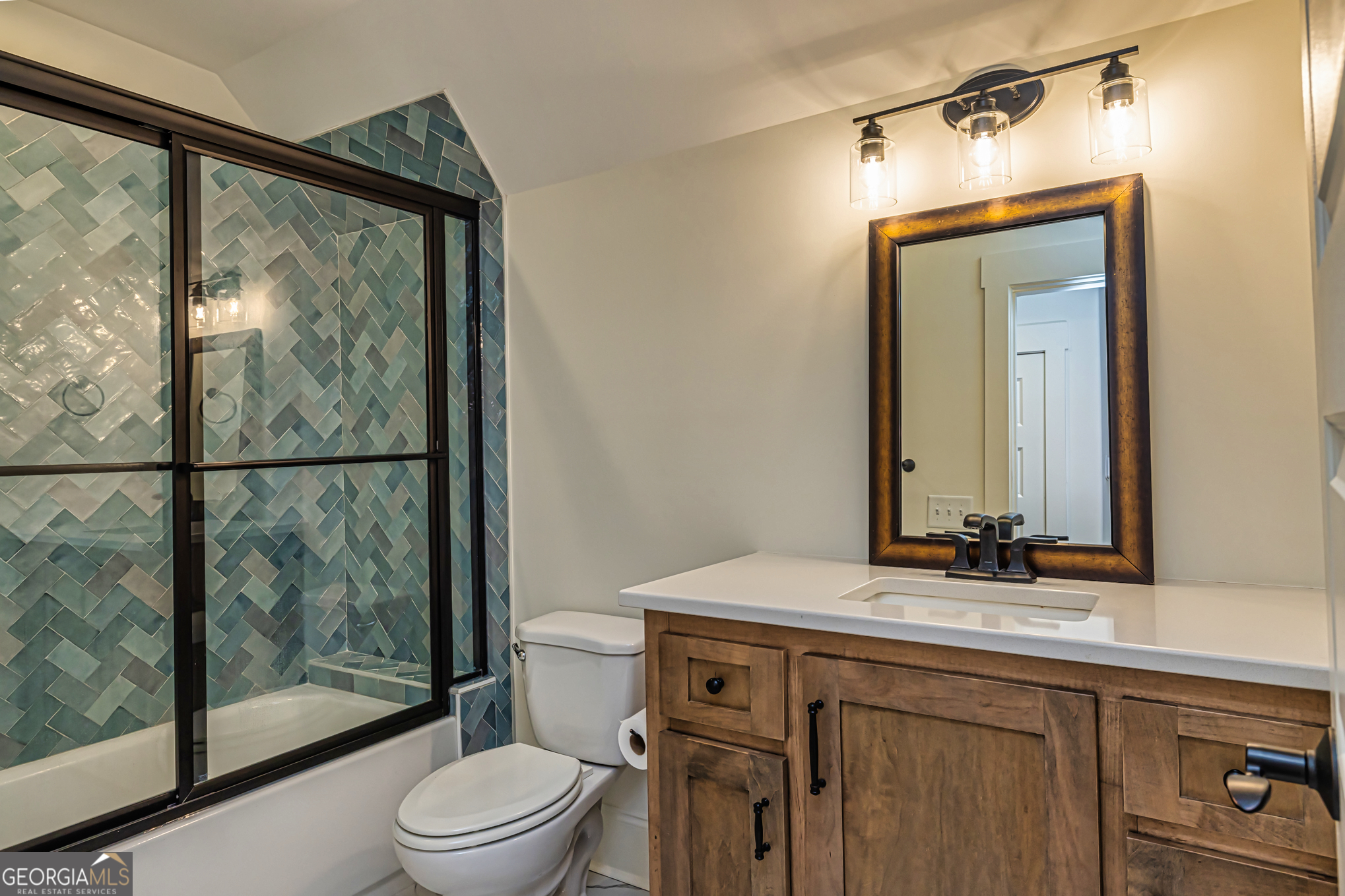 11084 Mt Carmel Road Senoia, GA 30276 - Photo 45 of 136 a bathroom with a toilet a sink a mirror and a shower