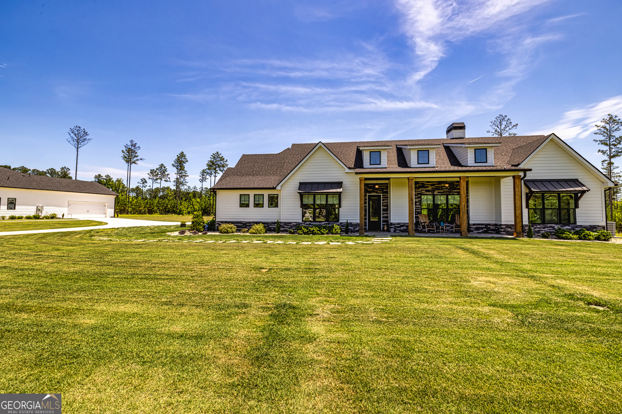 11084 Mt Carmel Road Senoia, GA 30276 - Photo 50 of 136 a front view of a house with a swimming pool