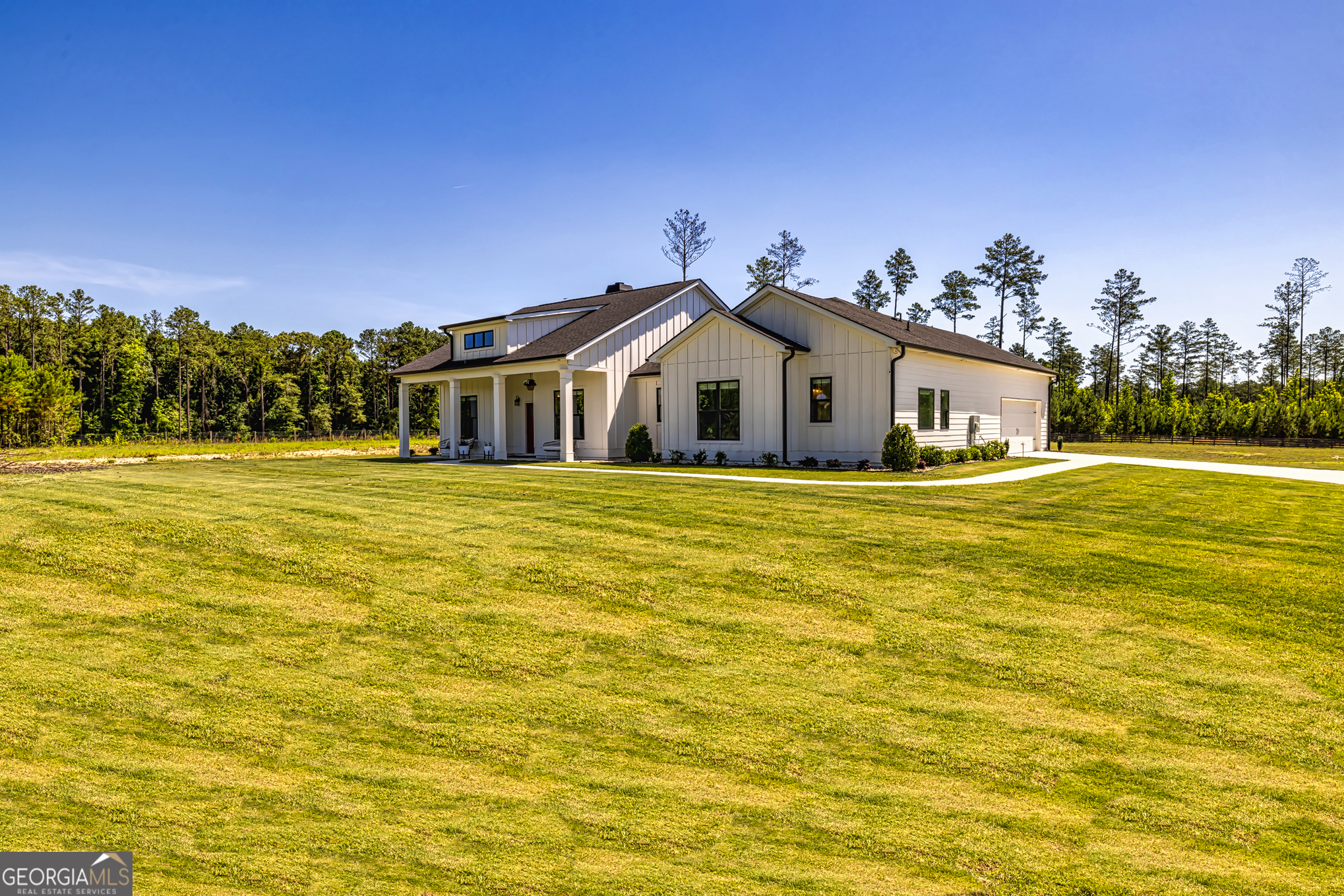 11084 Mt Carmel Road Senoia, GA 30276 - Photo 60 of 136 a white house with a large pool of the house in front of it