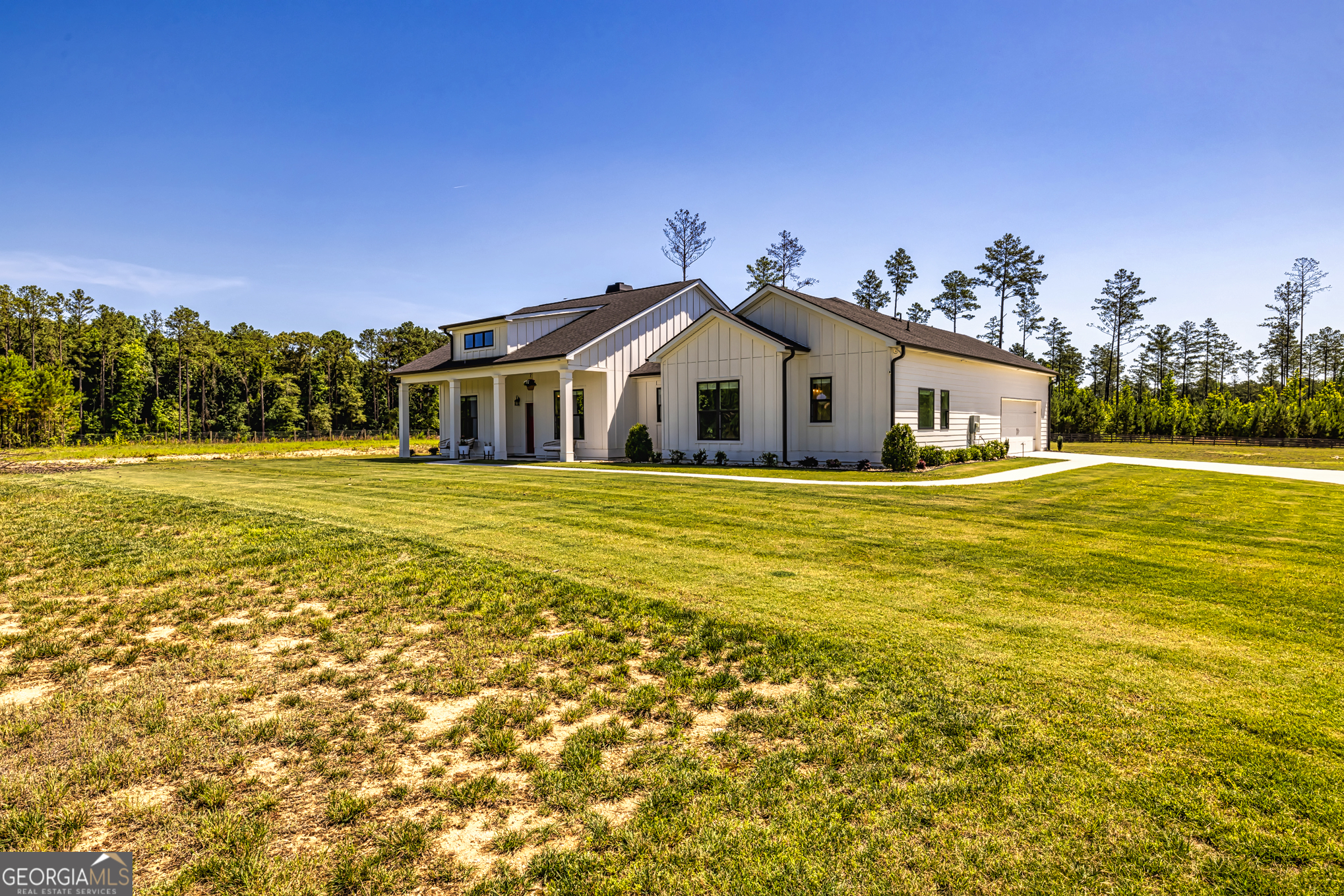 11084 Mt Carmel Road Senoia, GA 30276 - Photo 68 of 136 a white house with a large pool of the house in front of it