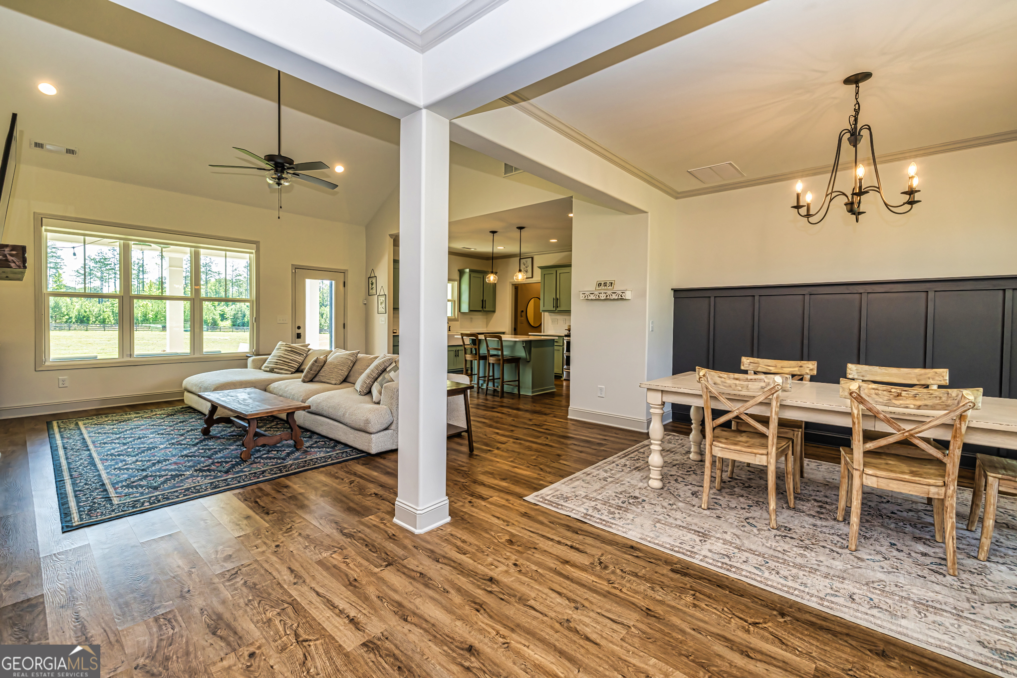 11084 Mt Carmel Road Senoia, GA 30276 - Photo 71 of 136 a dining room with wooden floor a chandelier a wooden table and chairs