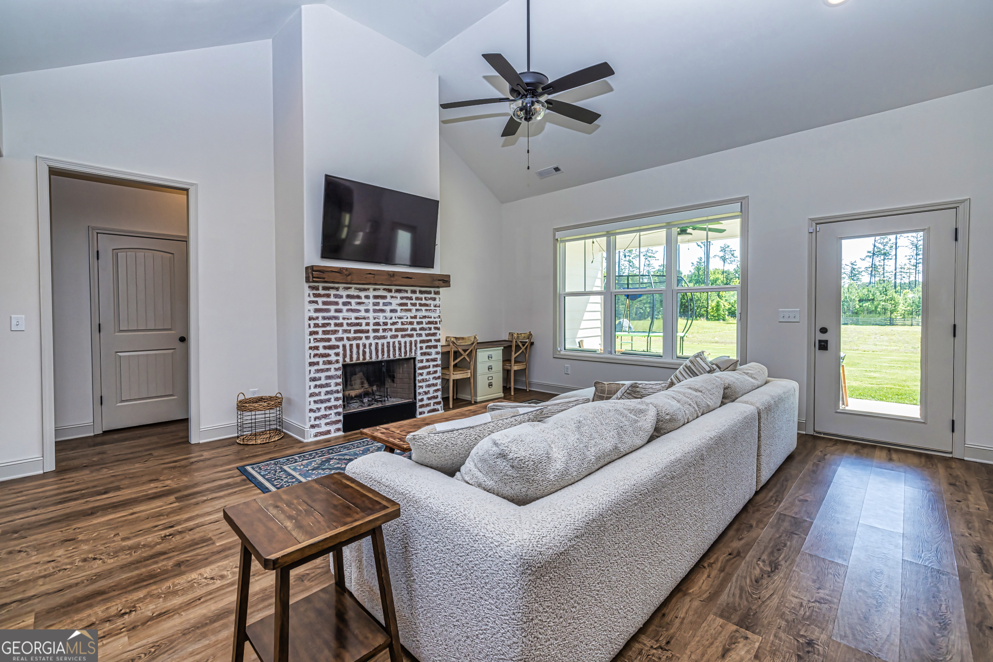 11084 Mt Carmel Road Senoia, GA 30276 - Photo 75 of 136 a living room with furniture a fireplace and a flat screen tv