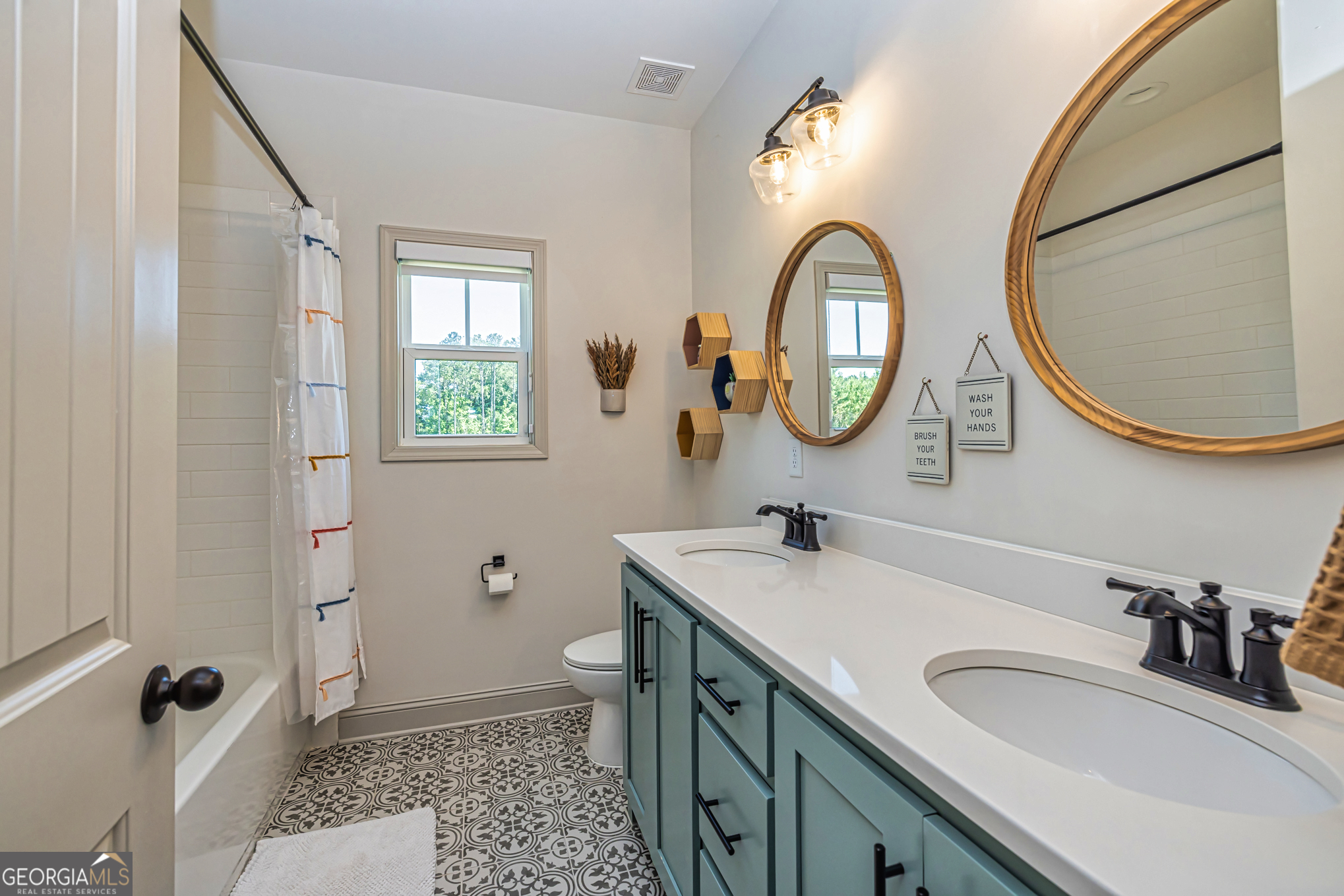 11084 Mt Carmel Road Senoia, GA 30276 - Photo 85 of 136 a bathroom with a toilet a sink and a mirror
