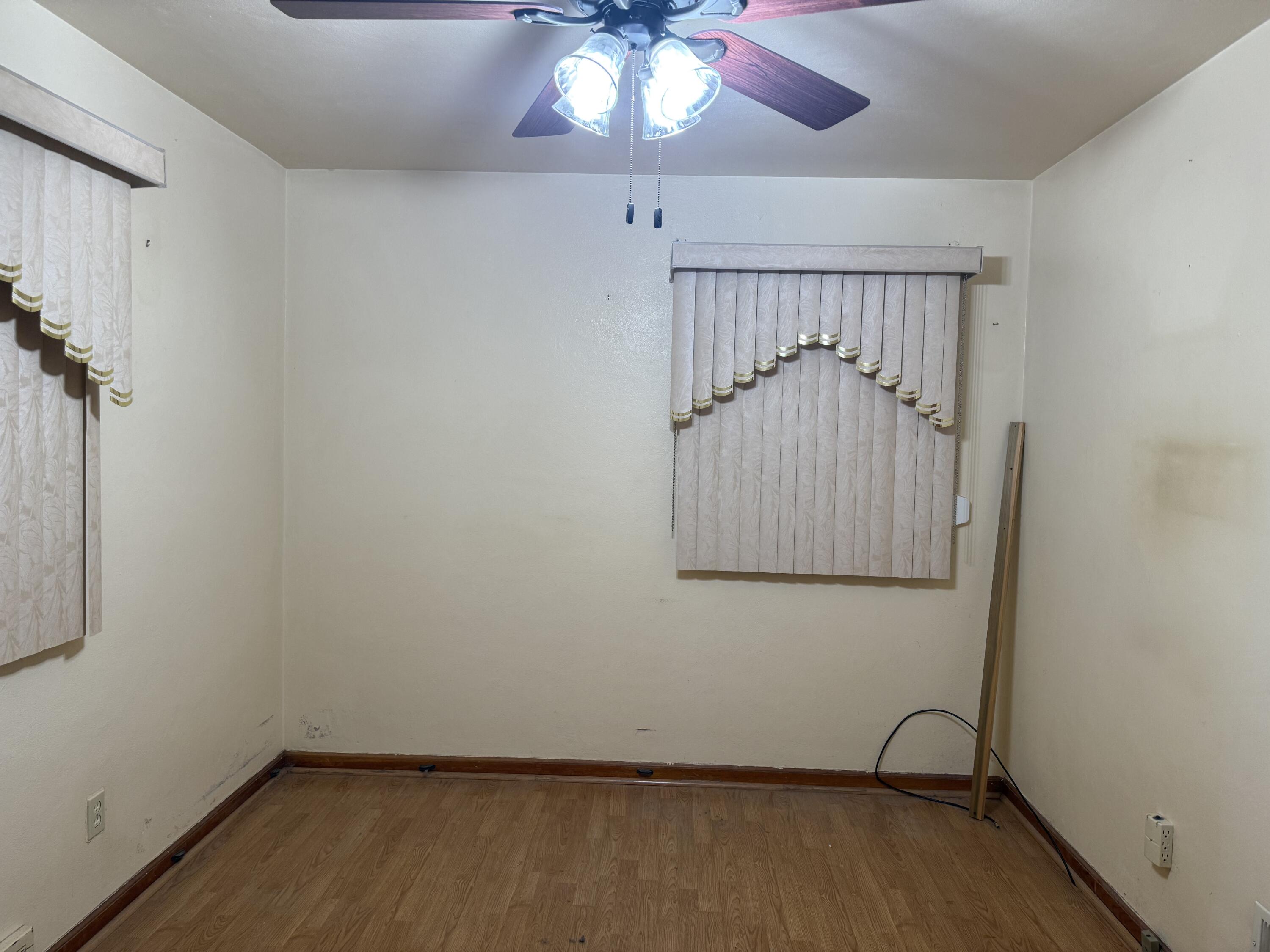 562 Dallas Street Gary, IN 46406 - Photo 6 of 15 a view of room with a ceiling fan and wooden floor