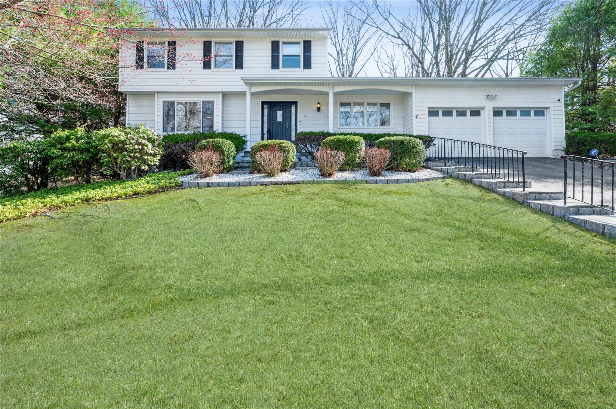 14 Reeback Drive Ossining, NY 10562 - Photo 1 of 37 View of front of house with a front yard, an attached garage, and concrete driveway