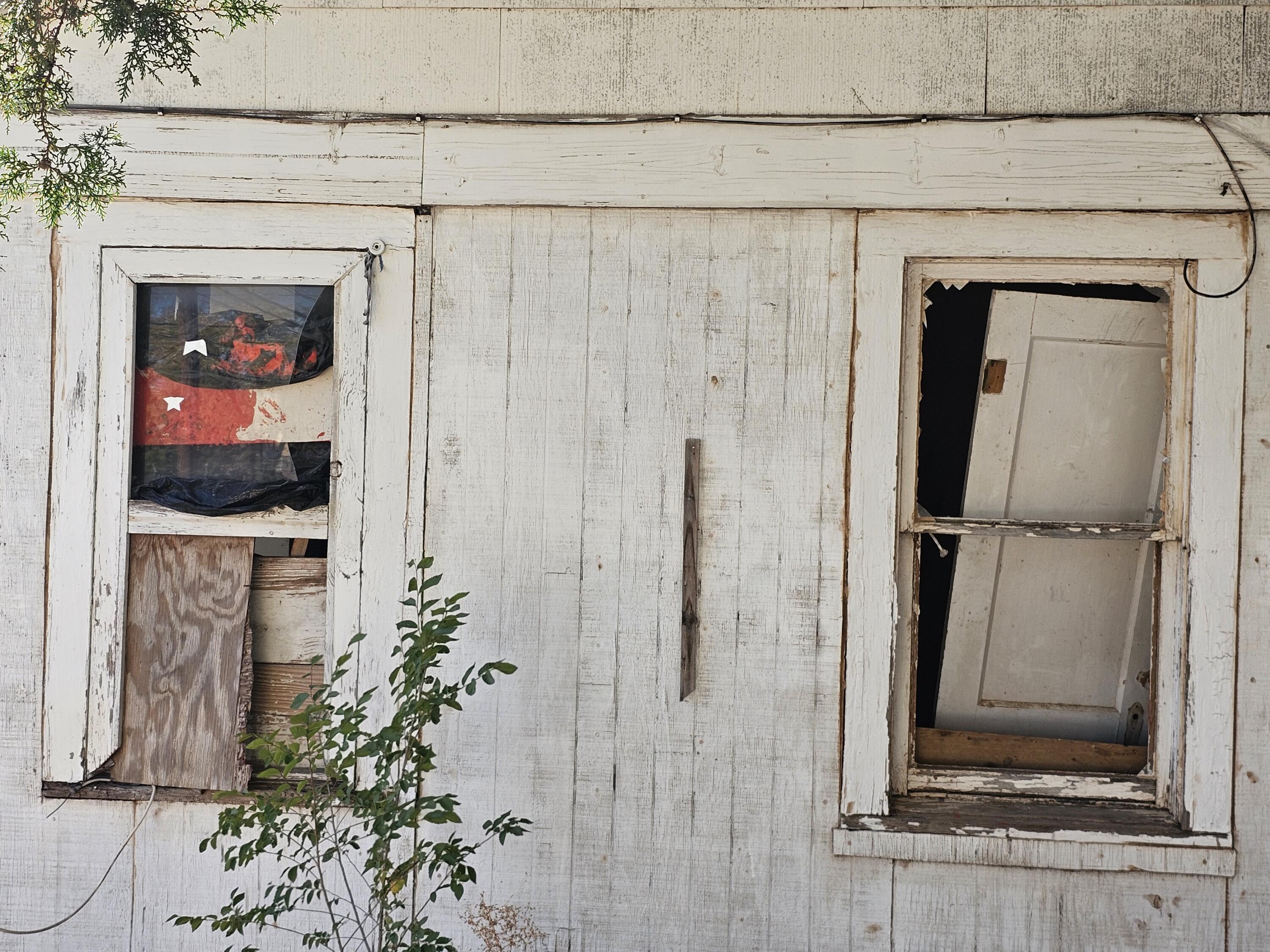 1514 18th Street Lubbock, TX 79401 - Photo 10 of 47 a living room with a fireplace and a flat screen tv