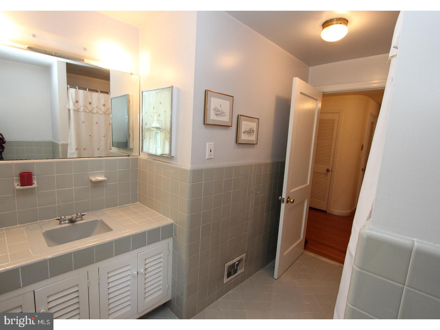 1664 Weedon Road Wayne, PA 19087 - Photo 19 of 24 a bathroom with a sink a mirror and a shower