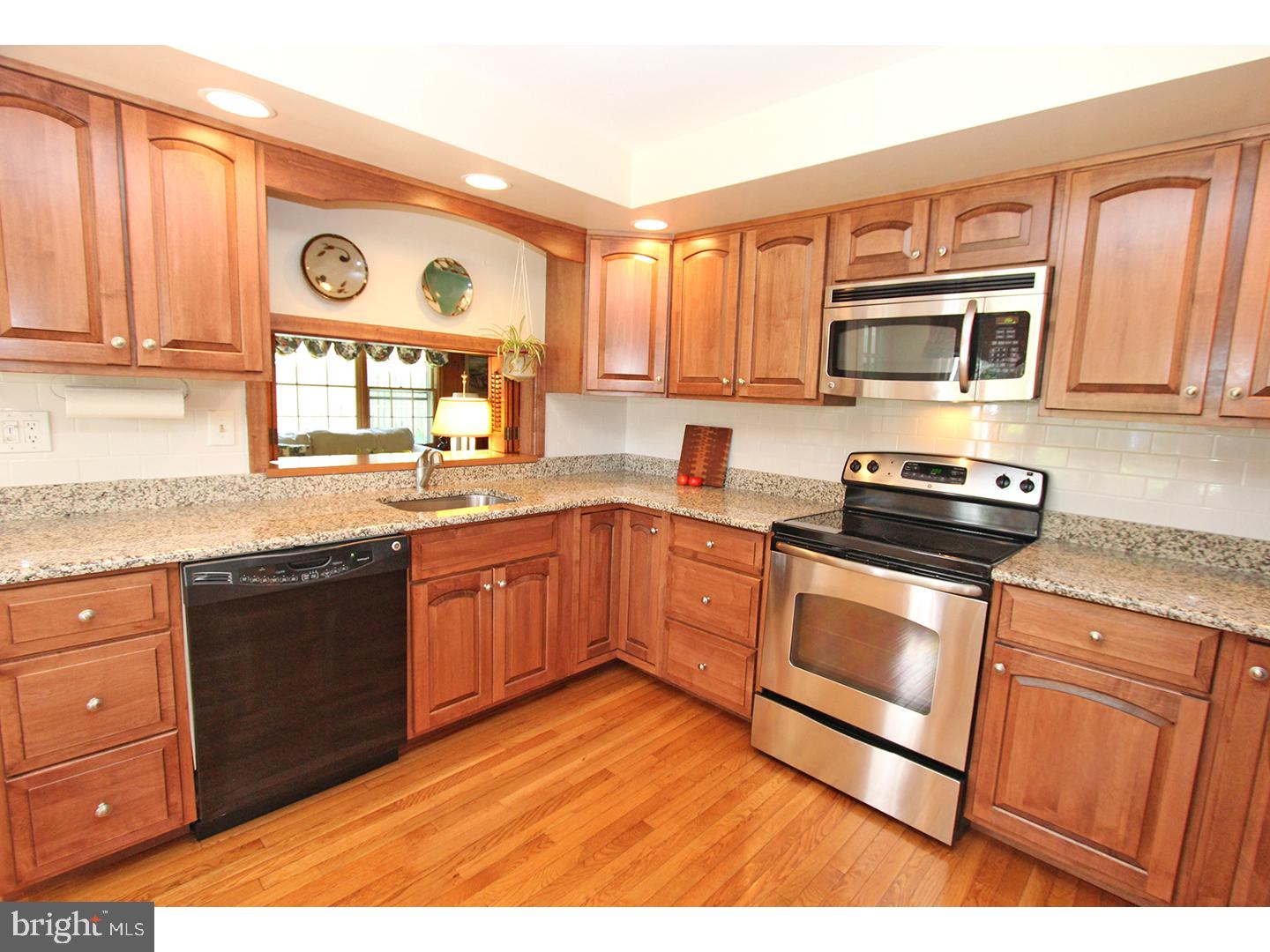 1664 Weedon Road Wayne, PA 19087 - Photo 8 of 24 a kitchen with stainless steel appliances granite countertop a stove a sink and a microwave