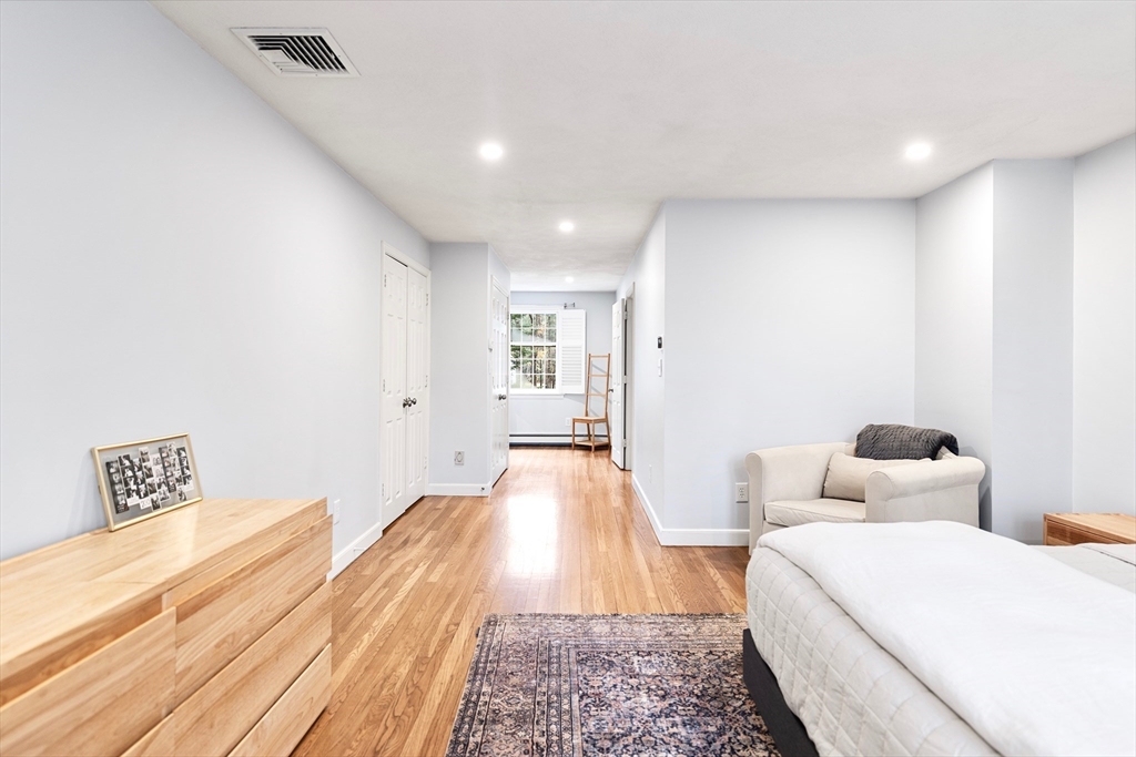 21 Batchelder Road Boxford, MA 01921 - Photo 19 of 37 a spacious bedroom with a bed and wooden floor