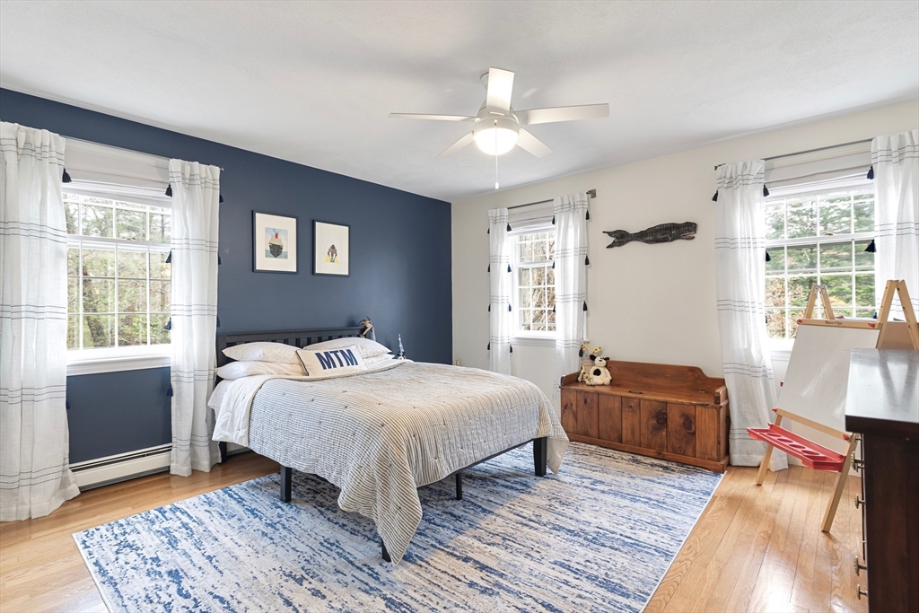 21 Batchelder Road Boxford, MA 01921 - Photo 22 of 37 a bedroom with a bed and wooden floor