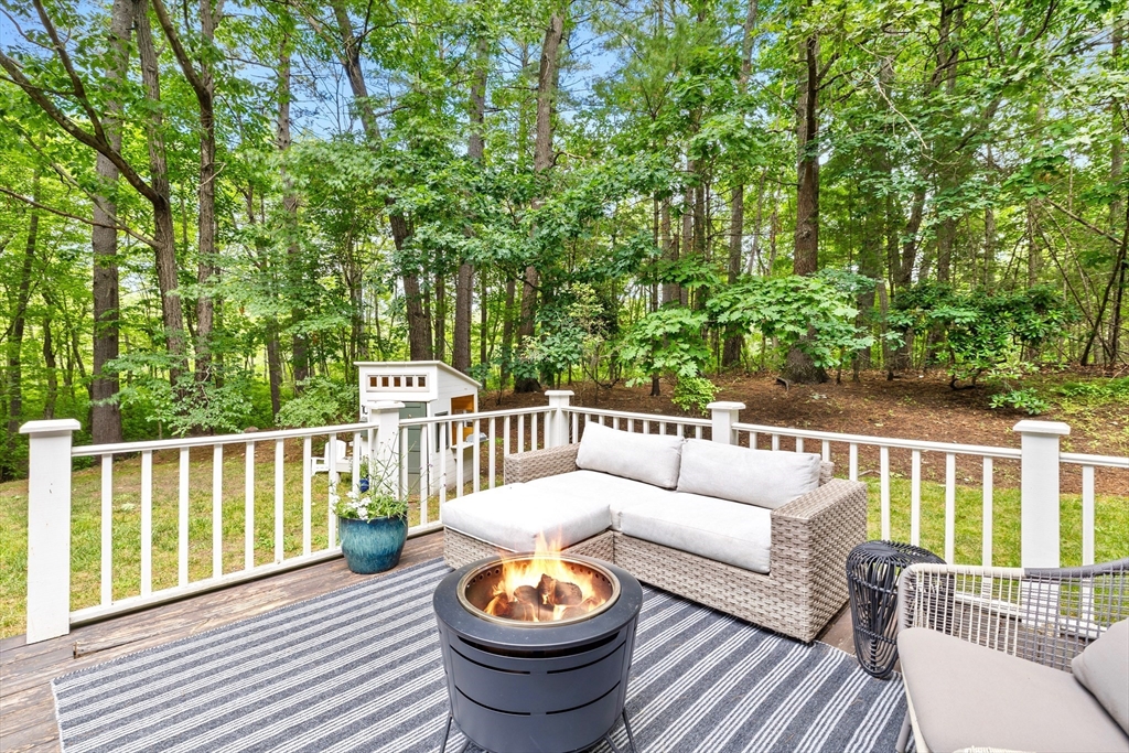 21 Batchelder Road Boxford, MA 01921 - Photo 31 of 37 a view of a chair and table on the wooden deck