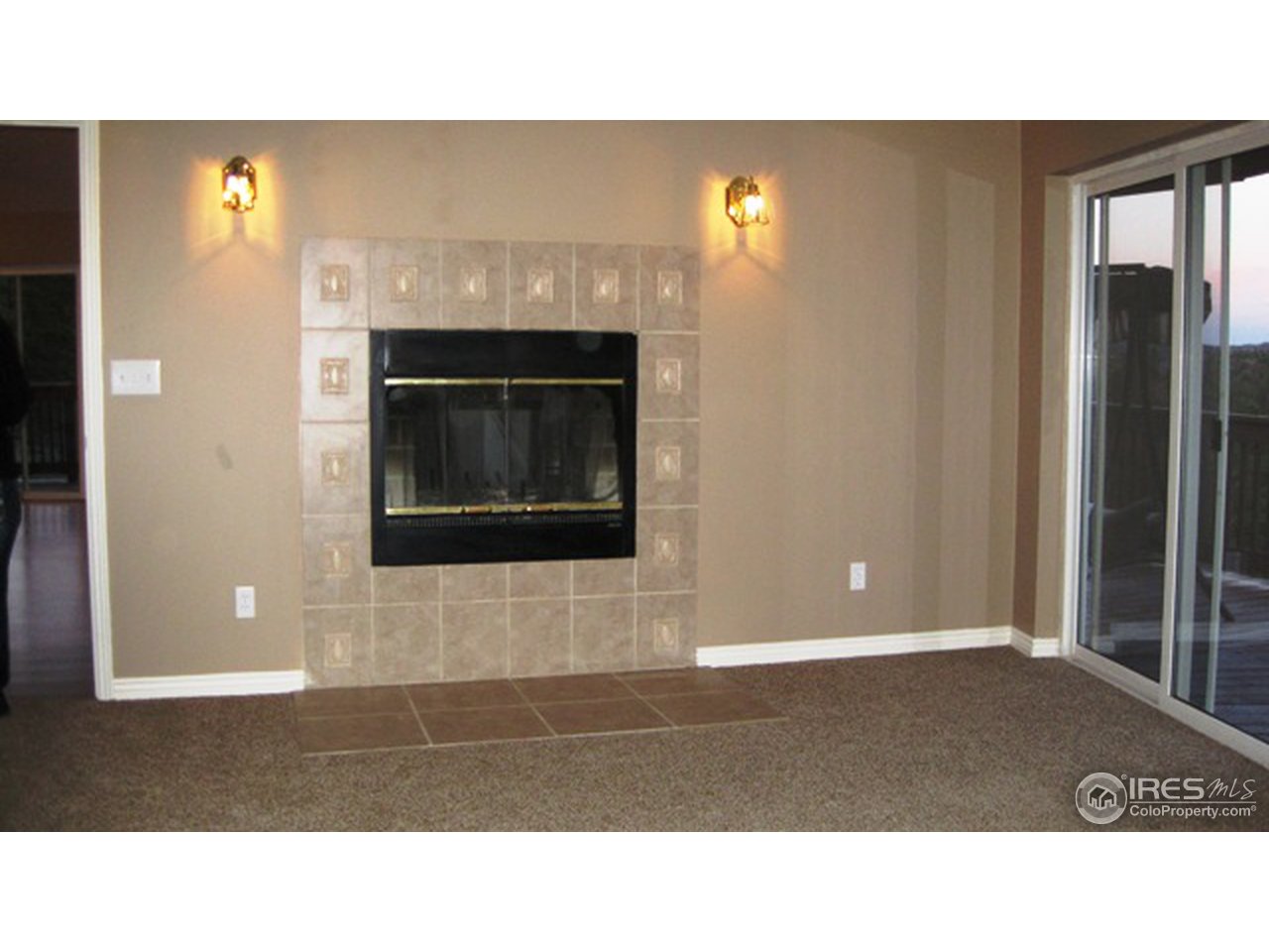 222 Beartrap Road Red Feather Lakes, CO 80545 - Photo 15 of 24 Master Bedroom fireplace and slider to deck