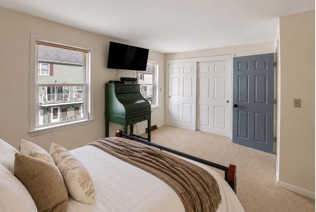 53 Century Way, Unit 53 Gardner, MA 01440 - Photo 19 of 22 a bedroom with a bed and a television