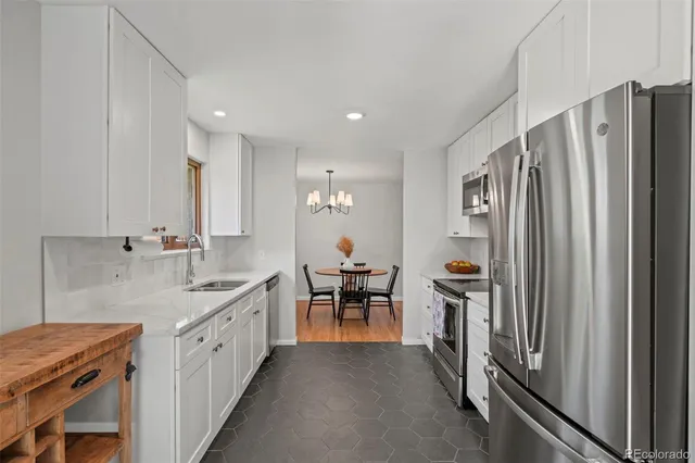 a large kitchen with a table and chairs