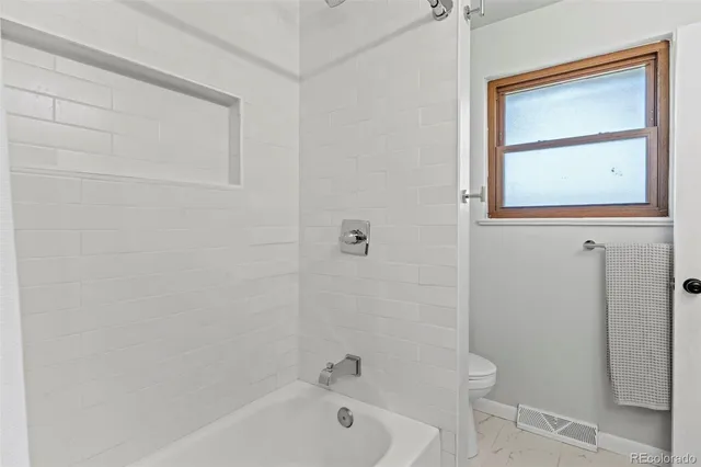 a bathroom with a bathtub toilet and sink