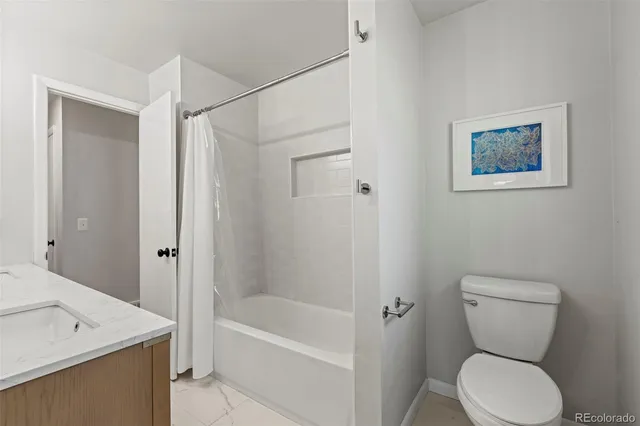 a bathroom with a toilet sink and shower