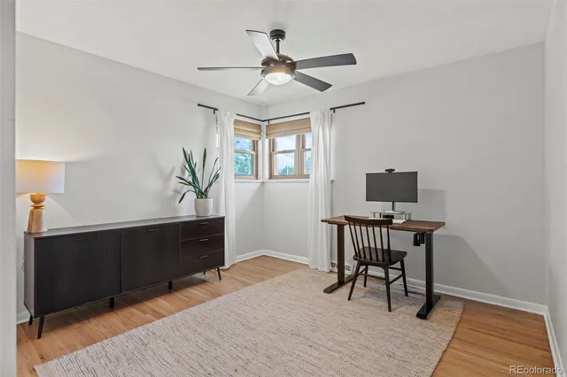 a workspace with furniture window and wooden floor