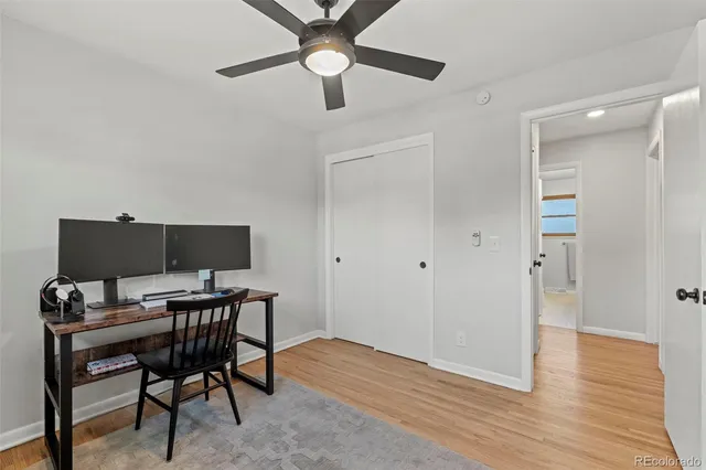 a view of a workspace with furniture and wooden floor