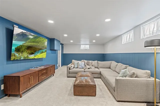 a living room with furniture and wall painting