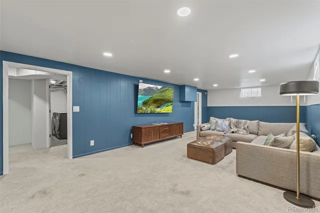 a living room with furniture and a projector screen