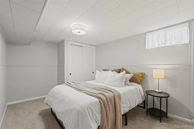 a bedroom with a bed and a night stand