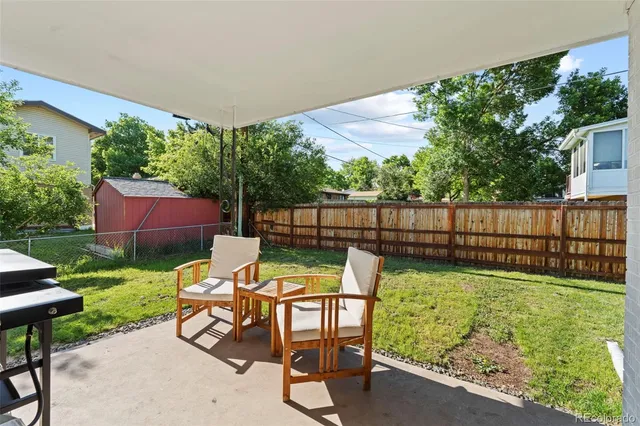 a view of backyard with seating area and green space